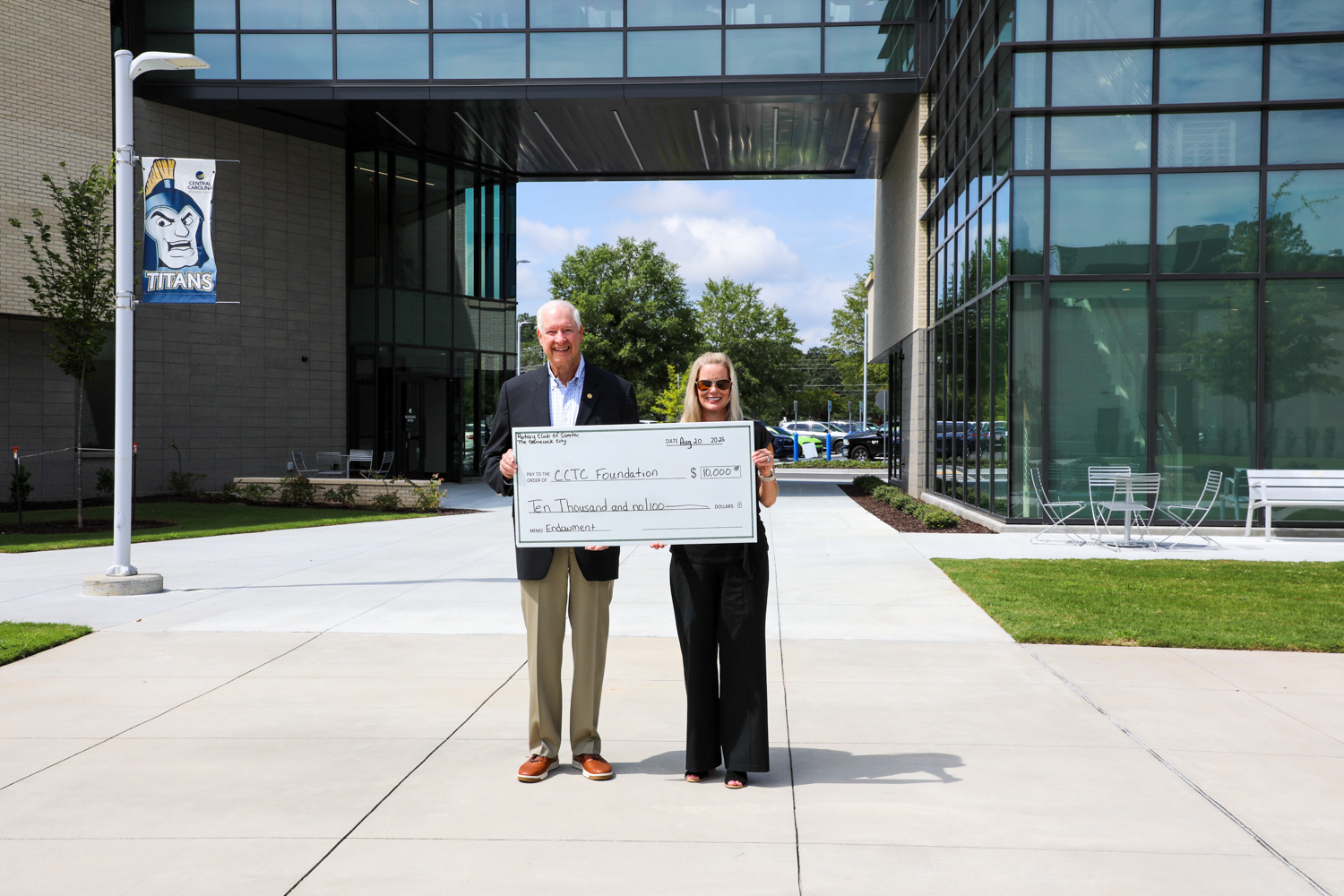 Misty Hatfield, CCTC Vice President for Institutional Advancement, accepts a gift from Rotary Club of Sumter–Gamecock City Scholarship Chair Cliff Goodwin to establish an endowed scholarship for CCTC students.